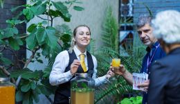 A woman handling drinks to a man
