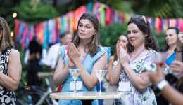 Two woman clapping in an outdoor setting